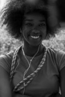 portrait of young afro american woman in gym while listening music photo