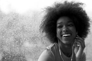 portrait of young afro american woman in gym while listening music photo