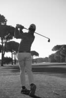 golf player hitting shot photo