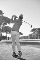 golf player hitting shot with club photo