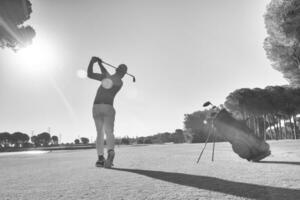 golf player hitting shot with club photo