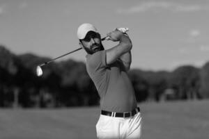 golfer hitting a sand bunker shot photo