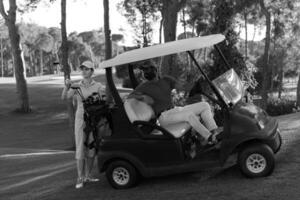 couple in buggy on golf course photo