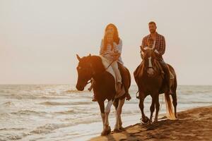 The family spends time with their children while riding horses together on a sandy beach. Selective focus photo