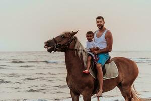 Father and son enjoy riding horses together by the sea. Selective focus photo