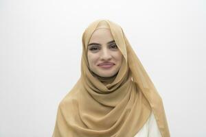 Portrait of young muslim woman wearing hijab on isolated white background photo