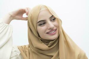 Portrait of young muslim woman wearing hijab on isolated white background photo