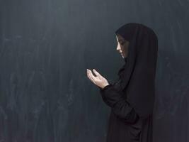 Portrait of young Muslim woman making dua photo