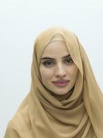 Portrait of young muslim woman wearing hijab on isolated white background photo