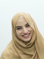 Portrait of young muslim woman wearing hijab on isolated white background photo