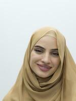 Portrait of young muslim woman wearing hijab on isolated white background photo