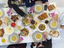 vista superior de la familia musulmana que tiene iftar durante el mes sagrado del ramadán foto