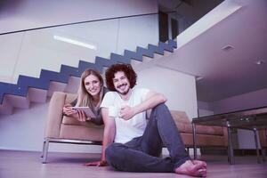 couple relaxing at  home with tablet computers photo