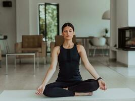 Young Beautiful Female Exercising, Stretching and Practising Yoga with Trainer via Video Call Conference in Bright Sunny House. Healthy Lifestyle, Wellbeing and Mindfulness Concept. photo