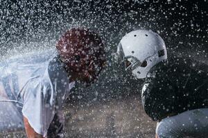 two american football players face to face in silhouette shadow on white background photo