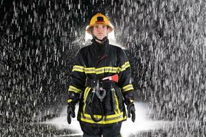 Portrait of a female firefighter standing and walking brave and optimistic. photo