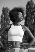 Portrait of sporty young african american woman running outdoors photo