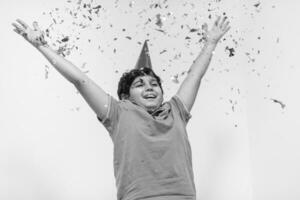 kid blowing confetti photo