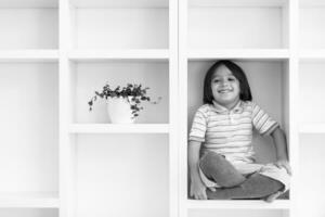 young boy posing on a shelf photo