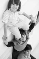 young boys posing line up piggyback top view photo