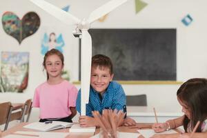 Elementary School Stem Robotics Classroom Diverse Group of Children Building and Programming windmill ecology robot concept. Together Talking and Working as a Team. Creative Robotics Engineering photo