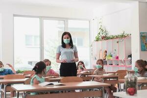 Preschool education. Students at school play interesting games with the teacher for the purpose of education photo