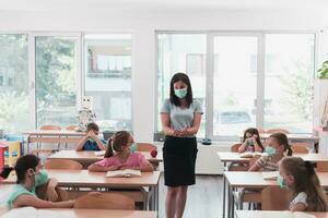 Preschool education. Students at school play interesting games with the teacher for the purpose of education photo