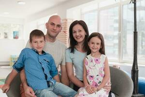 Portrait of a happy family. Photo of parents with children in a modern preschool classroom. Selective focus