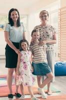 Portrait of a mother with her daughters in a modern preschool institution. Selective focus photo