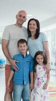 Portrait of a happy family. Photo of parents with children in a modern preschool classroom. Selective focus
