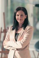 Young businesswoman smiling happy with arms crossed. Selctive focus photo