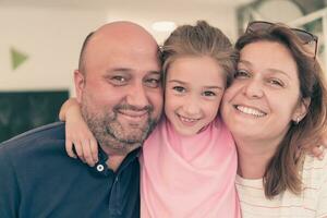 Portrait of a happy family. Photo of parents with children in a modern preschool classroom