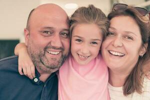 Portrait of a happy family. Photo of parents with children in a modern preschool classroom