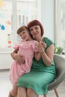 Portrait of a mother and daughter in a modern institution for preschool education photo