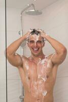 man taking shower in bath photo