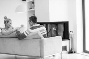 Young couple  in front of fireplace photo