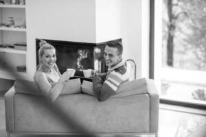 Young couple  in front of fireplace photo