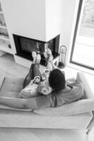 Young multiethnic couple  in front of fireplace photo