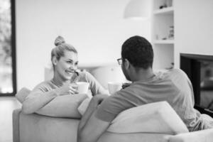 Young multiethnic couple  in front of fireplace photo