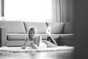 young women using tablet computer on the floor photo