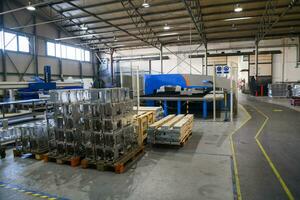 The first phase of metal and aluminum processing. Processed products from CNC machines stacked on a pallet in a large modern factory photo