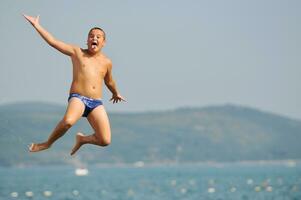 boy jump sea photo