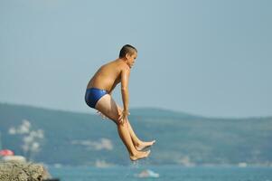 boy jump sea photo