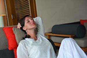 happy young woman relax at home on sofa photo