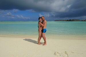 happy young couple have fun on beach photo