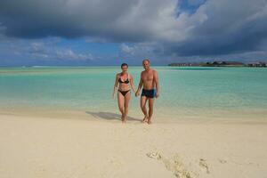 happy young couple have fun on beach photo