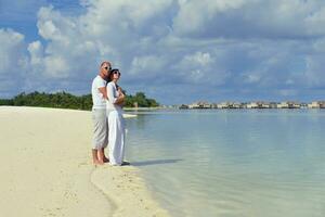 happy young couple have fun on beach photo
