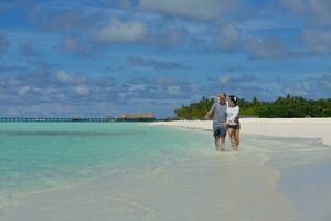 happy young couple have fun on beach photo