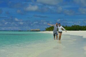 happy young couple have fun on beach photo