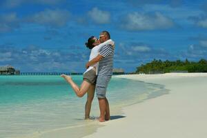 happy young couple have fun on beach photo